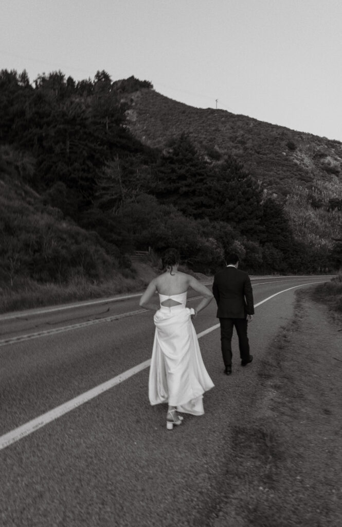 Bride and groom walking along the Big Sur coast